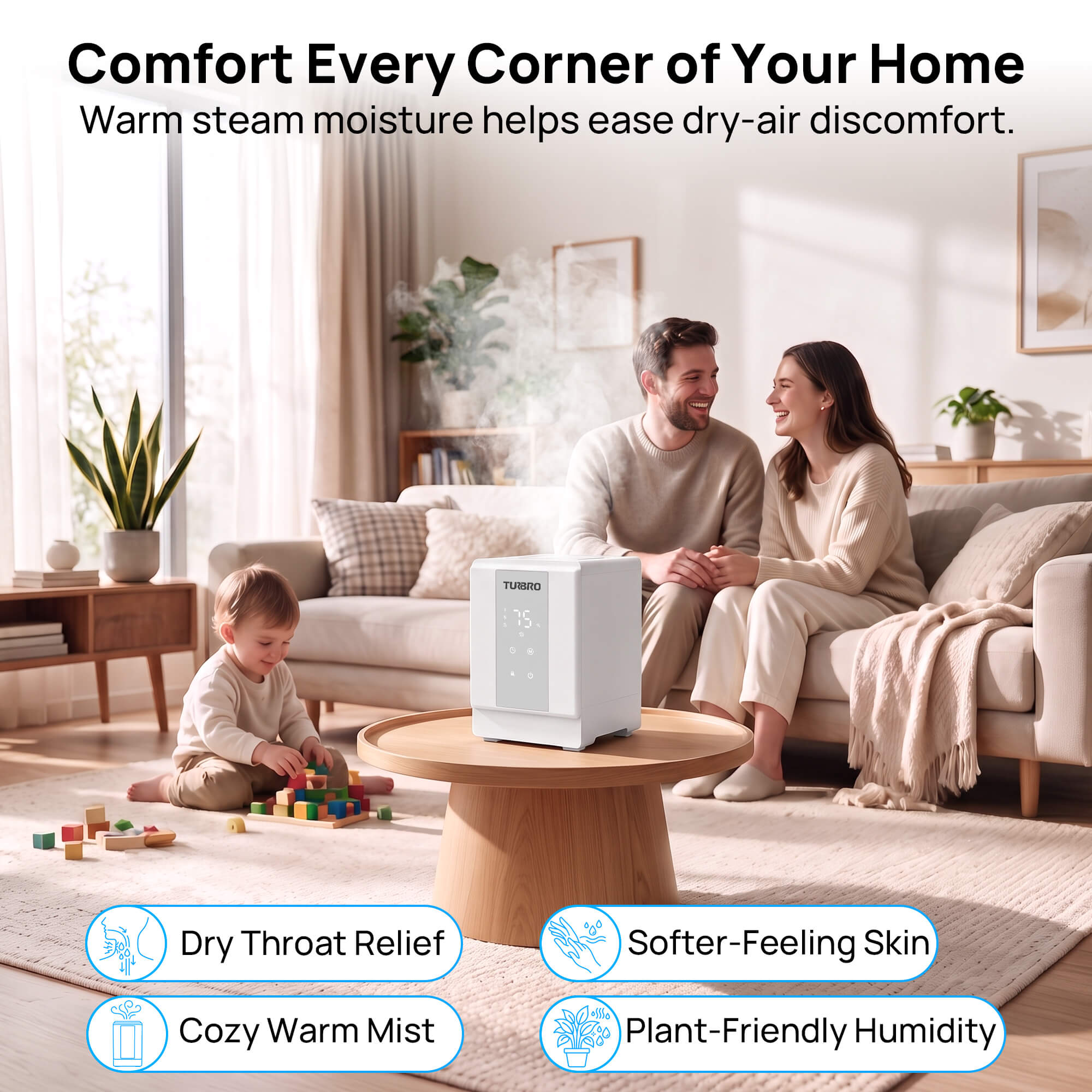 A white steam humidifier sits on a round wooden coffee table in a bright, modern living room. A man and woman are sitting on a sofa in the background, and a young child is playing with blocks on the floor.