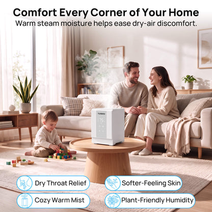 A white steam humidifier sits on a round wooden coffee table in a bright, modern living room. A man and woman are sitting on a sofa in the background, and a young child is playing with blocks on the floor.