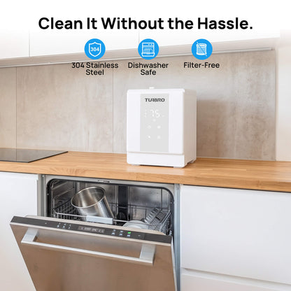 A white TURBRO compact dishwasher cleaner sits on a wooden kitchen countertop above an open stainless steel dishwasher. Text at the top reads 'Clean It Without the Hassle.